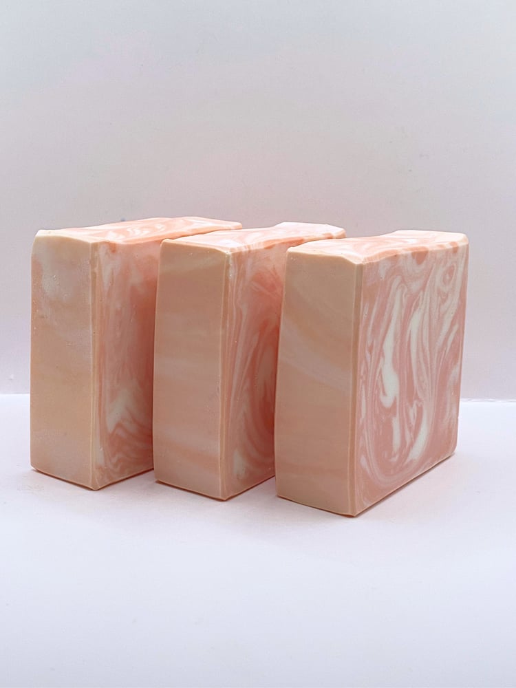 Three peachy-pink handmade soap bars