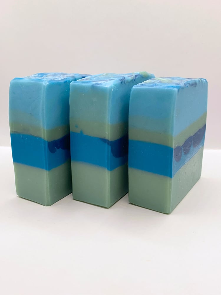 Three blue and green striped handmade soap bars