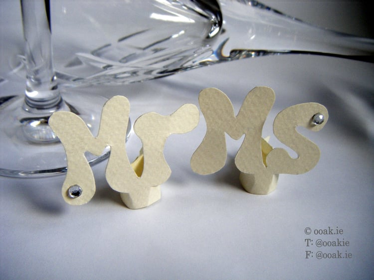 Mr and Ms wine glass tags made from cream card embellished with crystals for a wedding table