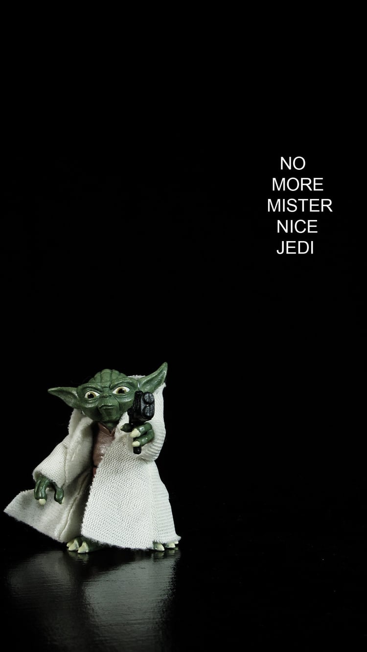 Yoda action figure on black back ground. he is pointing a blaster at the viewer. the text read "no more mr nice jedi"