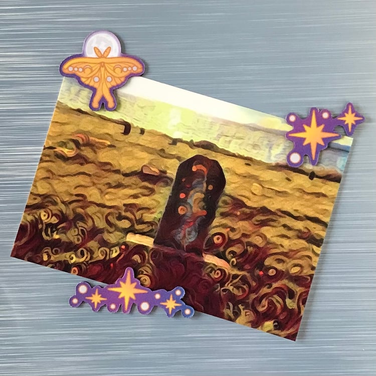 A trio of mini celestial magnets holding up a decorative postcard (each magnet can actually hold a 4" x 6" photo easily).
