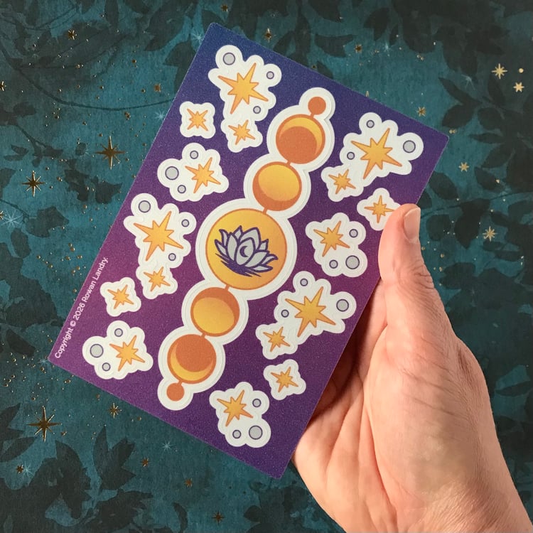 A vinyl sticker sheet shown in-hand for scale.