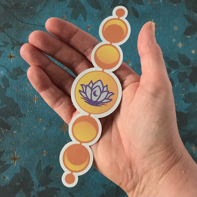 A lunar lotus vinyl decal shown in-hand for scale.