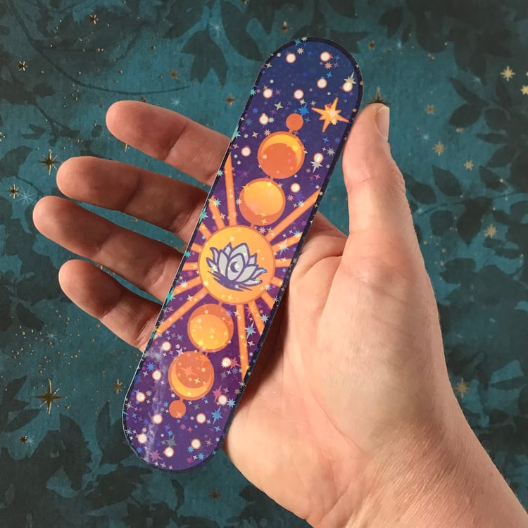 A large, celestial themed decal with lotus and moon phases plus starry laminate finish shown in-hand for scale.