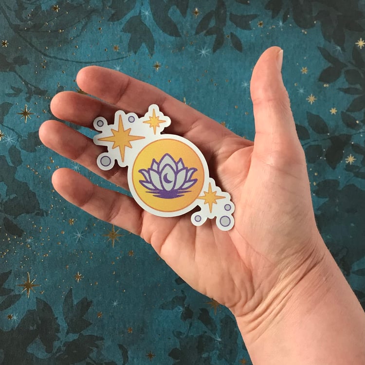 A lunar lotus themed decal shown in-hand for scale.