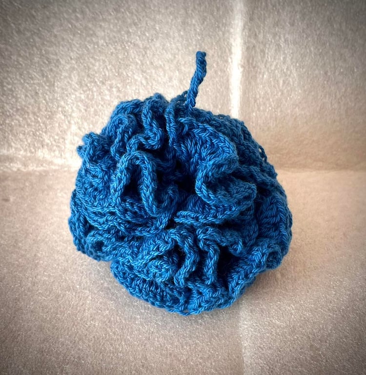 Blue crochet bath pouf made from cotton
