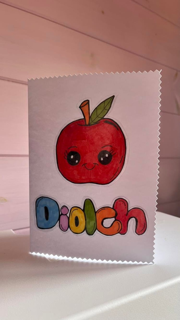 Handmade Welsh Diolch teacher thank you card with cute smiling apple character, hand drawn and handcrafted in Wales.