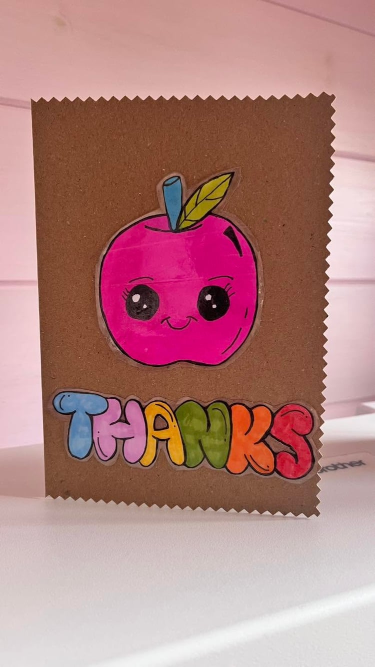 Handmade thank you card with cute smiling apple face design, hand drawn and handcrafted in North Wales UK.