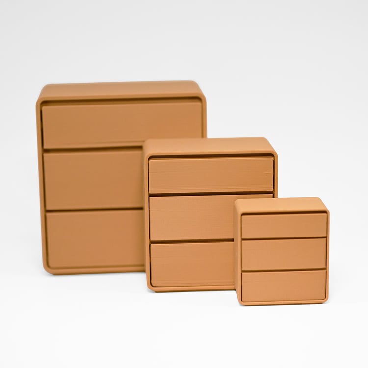 Three sizes of miniature 3d printed dressers in light brown