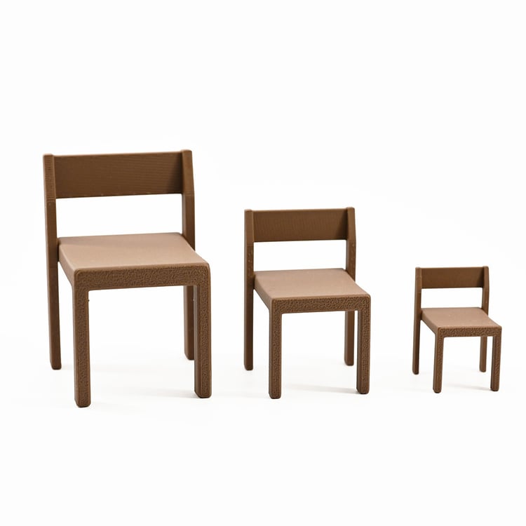 three miniature chairs in a row in descending sizes