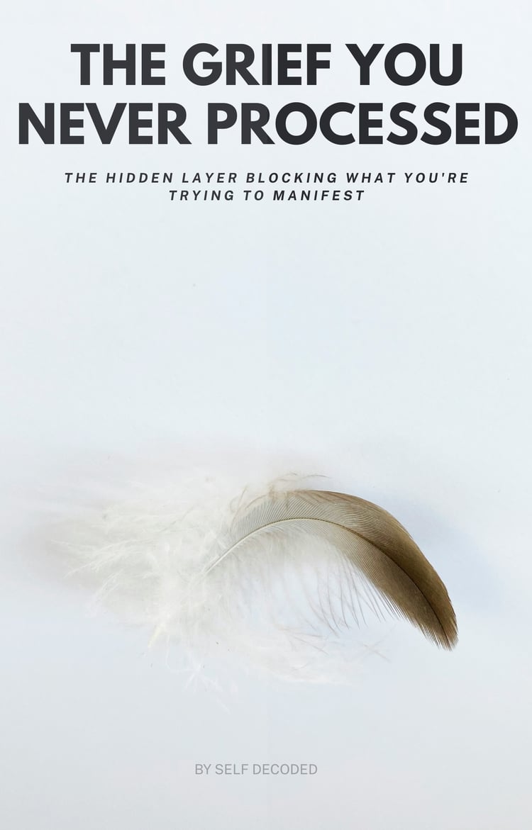 The Grief You Never Processed — free ebook by Self Decoded about how unprocessed grief blocks manifestation, cover image of a feather on a white background