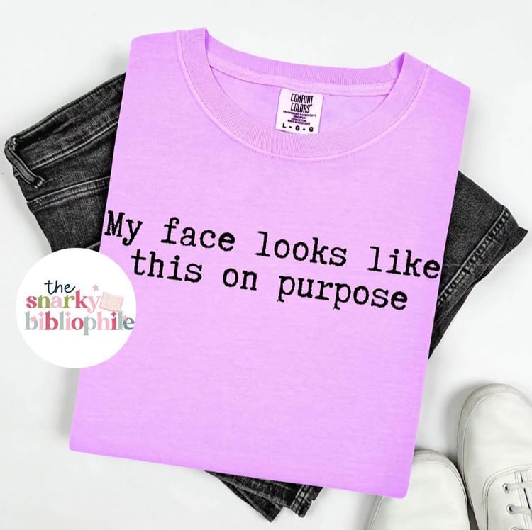 Neon purple comfort colors t-shirt with black typewriter print that says my face looks like this on purpose. Unisex fit and savailable in sizes small through three x.