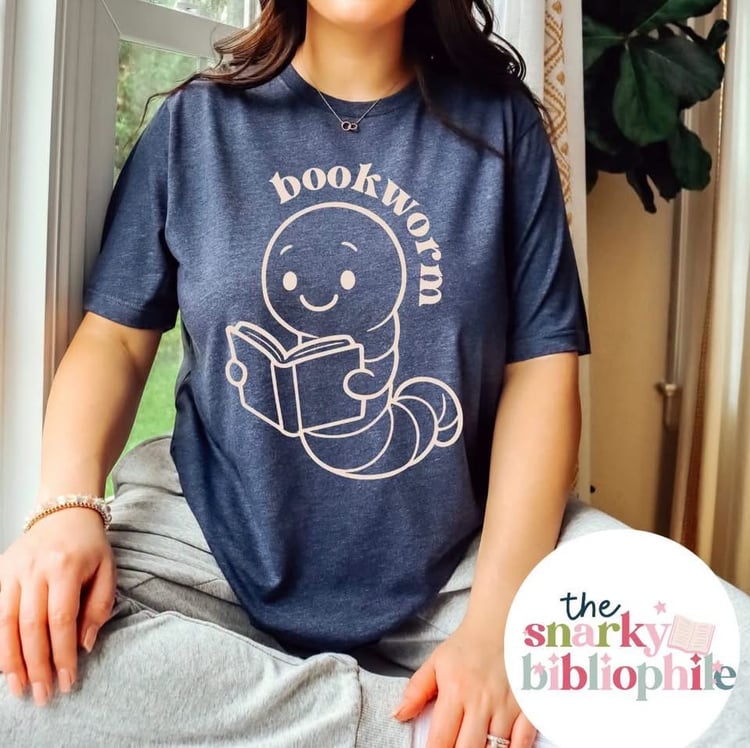 navy shirt with a cute worm holding a book and the word bookworm in a cream font