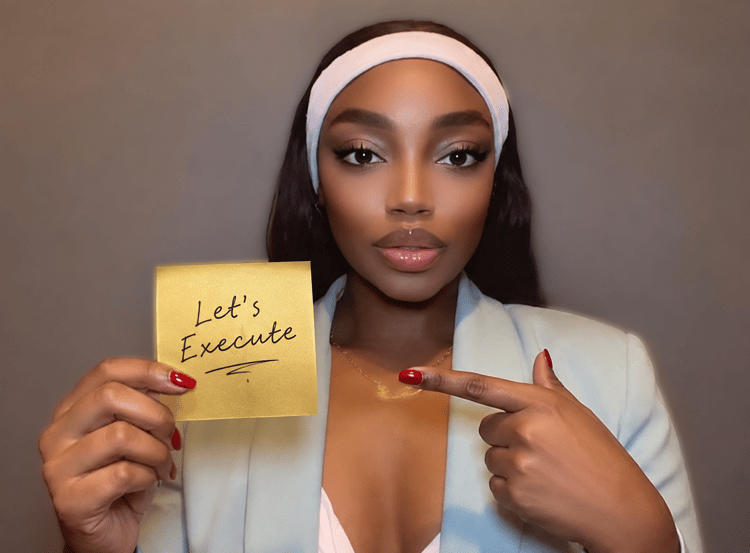 Treyana Harry holding a sticky note that says ‘Let’s Execute’ — Sharpen with the 3 Pillars of Success