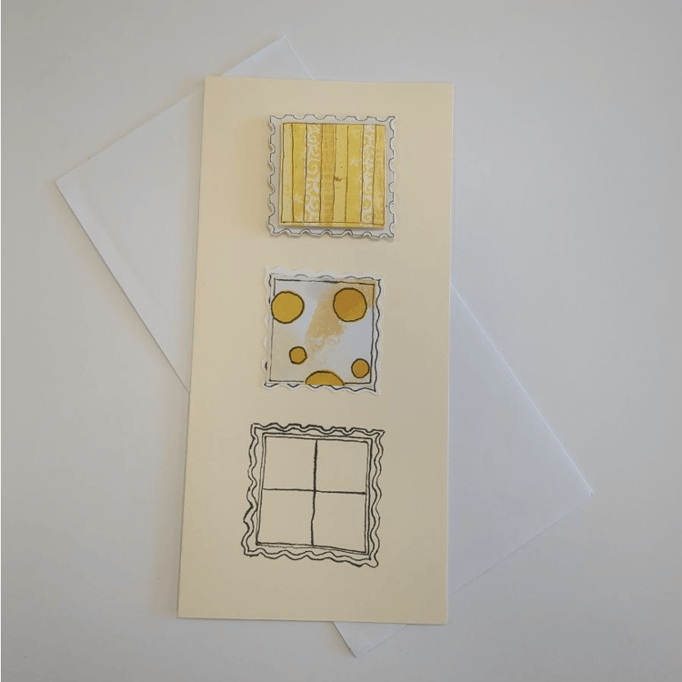 A tall cream card with white envelope. Three squares with postage stamp effect edges are centred down the middle of the card. The top one has vertical stripes of yellow on a white background and is raised. The middle one is less raised and has yellow spot
