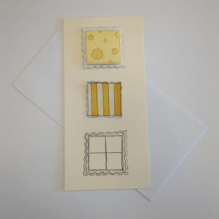 A tall card in cream with a white envelope. Three squares with postage stamp edges are centred down the middle of the card. The top one is raised and has yellow spots resembling Swiss Cheese on a white background. The middle one has vertical yellow stripe