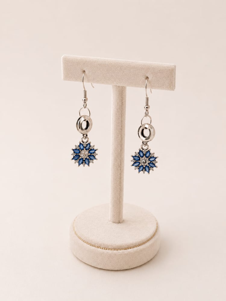 Handmade 925 sterling silver bridal drop earrings featuring a brilliant blue and clear crystal sunflower burst charm