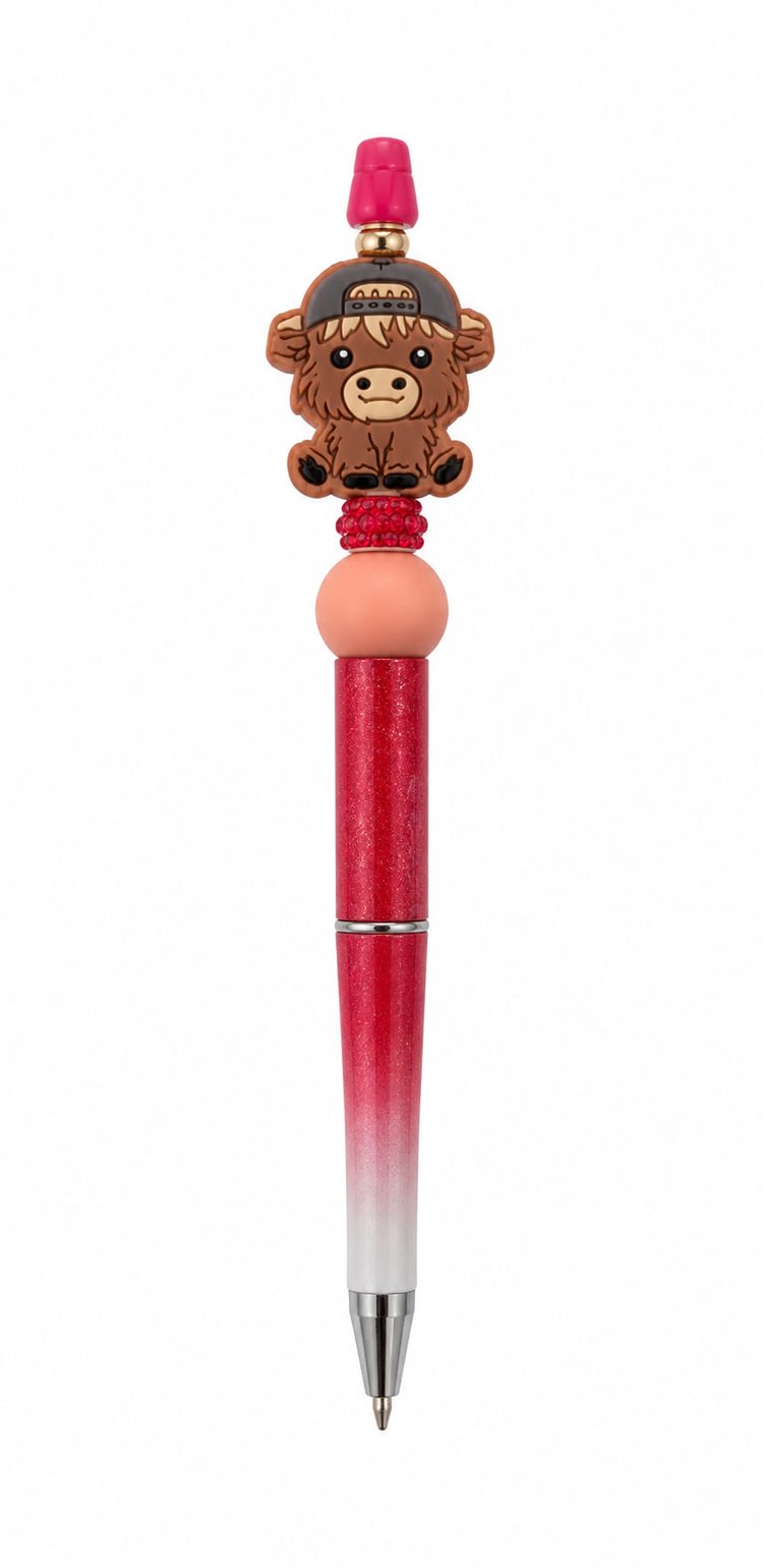 A red gradient custom beaded pen featuring a backward cap Highland cow focal bead, a sparkling red rhinestone spacer, and a peach accent bead.