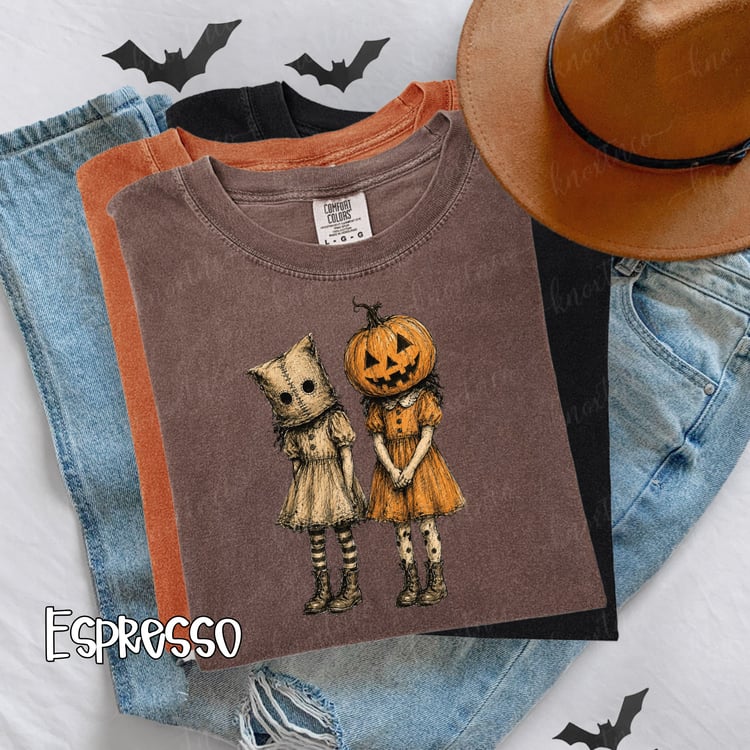 A perfectly spooky vintage Halloween shirt featuring pumpkin-head and masked girls in a distressed hand-drawn style. Available on a Comfort Colors tee or Gildan sweatshirt in sizes Small to 3X, pressed and shipped by our small family business in East Tenn