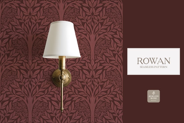 Hand drawn seamless pattern featuring woodland trees and leaves in red burgundy on wallpaper behind a wall sconce