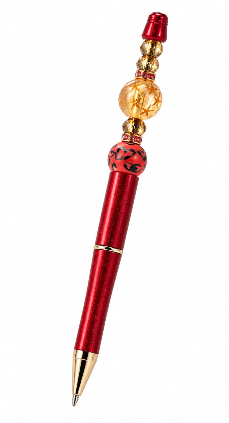 A close-up view of a custom metallic red ballpoint pen with gold trim, decorated with a red leopard print focal bead, faceted amber crystal spacers, and pink rhinestone column bands.