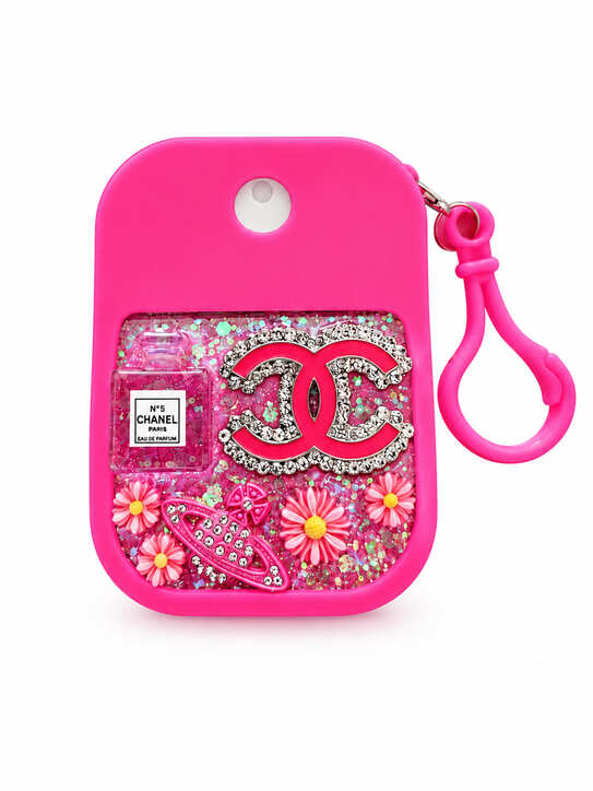 Hot pink hand cleaner keychain holder decorated with resin, flowers, glitter and sparkling embellishments