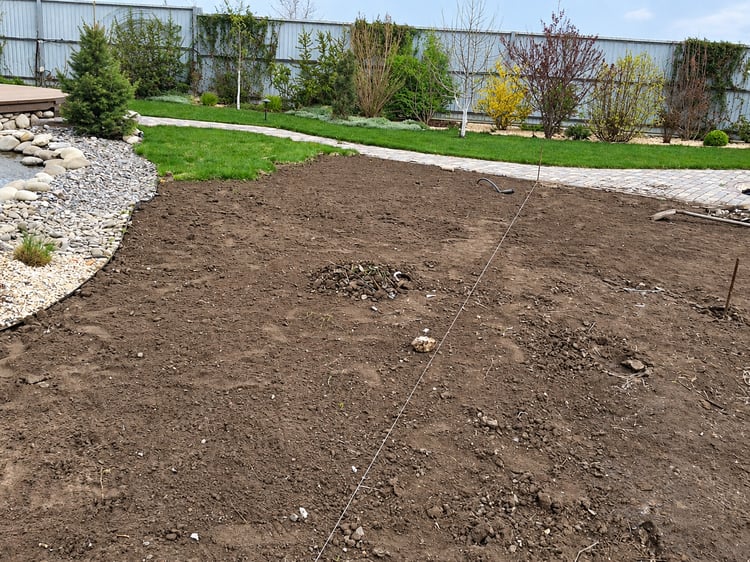 Preparation of the future lawn area in a large private family garden before grass establishment.