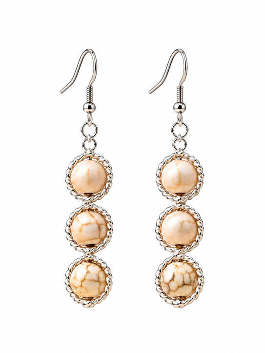Close-up of handmade 925 sterling silver triple drop earrings with genuine natural white stone beads.
