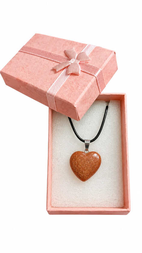 Goldstone heart necklace presented in an open pink jewellery gift box with satin ribbon bow.