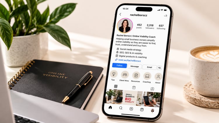 Smartphone displaying an optimised small business Instagram profile with a clear business bio, website link and contact buttons, on a cream-coloured desk beside a notebook and coffee.