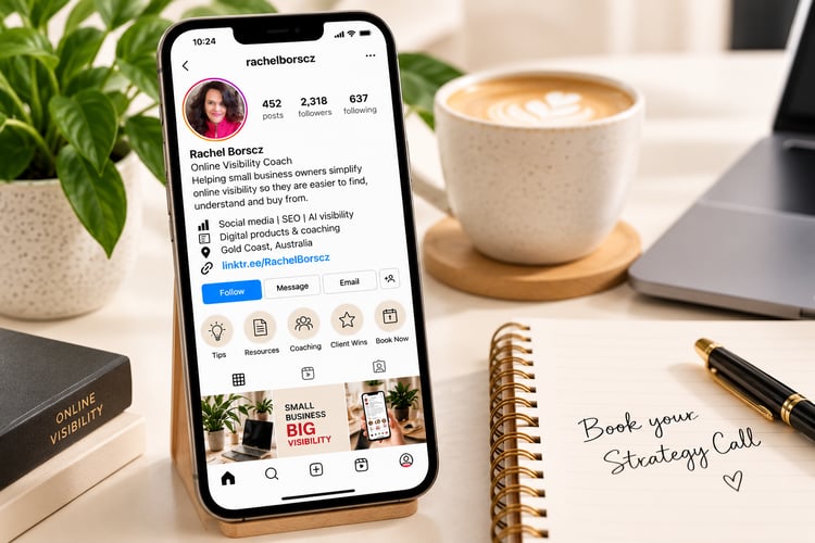 Smartphone displaying Rachel Borscz's Online Visibility Coach social media profile with a clear bio, clickable link and booking highlight, beside a notebook reading Book Your Strategy Call on a cream-coloured desk.