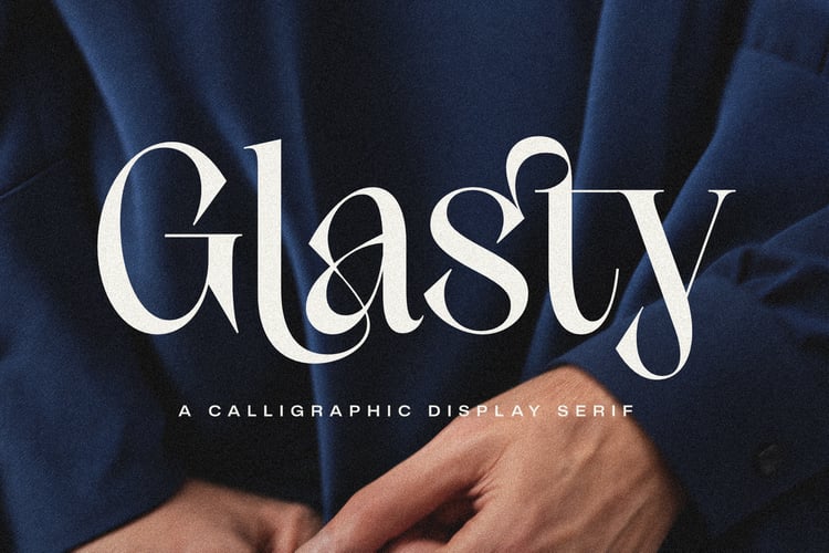 Glasty calligraphic display serif over navy suit fabric close-up