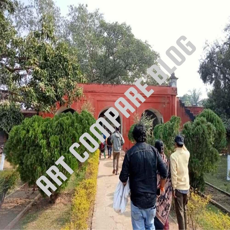 Tourists Walking Towards Red Arched Entrance Gateway Through Garden Path with Green Bushes - Khushbagh Cemetery Entry, Murshidabad