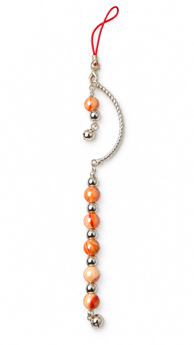 Handmade orange and silver Christmas hanging decoration with marbled orange beads, polished silver beads, crescent detail and jingle bells.