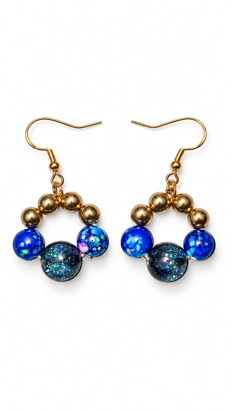 Handmade midnight blue circular beaded drop earrings with gold beads, marbled blue beads and shimmering dark focal beads on 18K gold-plated sterling silver hooks.