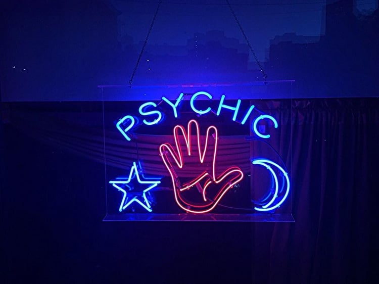 Google Images stock image of a neon sign "Psychic" with a star, hand, and moon crescent
