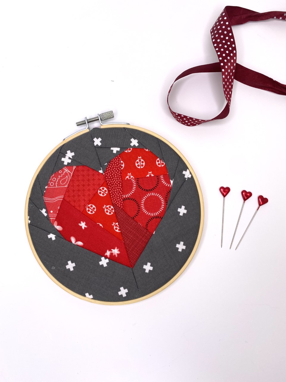 Paper Pieced Heart Quilt Block has been used to make Wall Art using an embroidery hoop in this quick and easy sewing project!