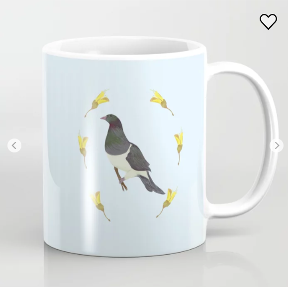 My artwork "Kereru Dreaming" shown on a coffee mug. The picture is a New Zealand native bird surrounded by kowhai flowers that I have hand-drawn.