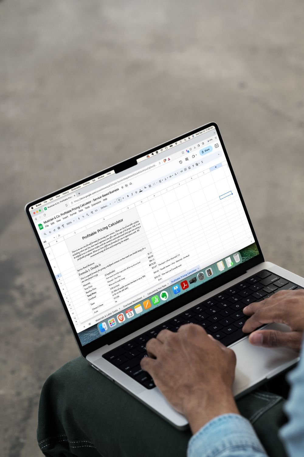 A person working on a laptop computer with pricing calculator for service-based musicians on the screen
