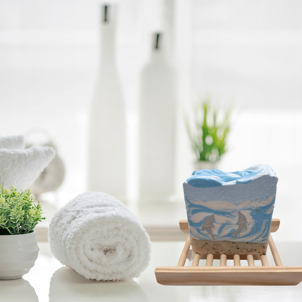 Bar of handmade soap sitting on top of a bamboo bar rack in a bathroom setting
