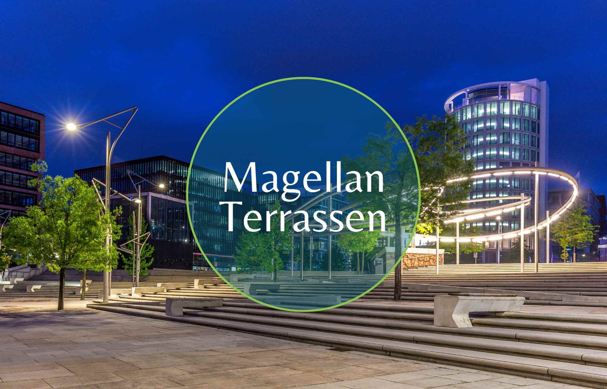 Nestled in the heart of Hamburg's HafenCity, the Magellan Terrassen offer a captivating synthesis of modern design and historical charm, creating an urban oasis spanning approximately 5,000 square meters. This enchanting space, resembling an amphitheater overlooking the Traditionsschiffhafen (Traditional Ship Harbor), beckons visitors to unwind, immerse themselves in the maritime atmosphere, and partake in a variety of cultural events.  Among the numerous open spaces in HafenCity, the Magellan Terrassen stand out for their impressive architecture and an irresistible fusion of tradition and modernity. It is a rare gem in Hamburg where one can sit so close to the Elbe River, linger on broad cascading steps, and absorb the rich maritime ambiance that permeates the air.  Structured in a stepped manner across multiple levels leading down to the water, the Magellan Terrassen provide visitors with breathtaking views of iconic landmarks such as the Elbphilharmonie concert hall, the Elbe River, and the Traditionsschiffhafen in Sandtorhafen. This harbor, in itself, is a unique attraction with its historic ships, sailboats, and innovative floating pontoons that rise and fall with the tides, ensuring constant access to the water. Restored historic quays elegantly connect the harbor to the Magellan Terrassen, creating a seamless blend of historical and contemporary elements.  Architectural elements of the Magellan Terrassen pay homage to the site's historical and maritime significance. "Carpet elements," vibrant floor ornaments, nod to the traditional carpet trade in the adjacent Speicherstadt, while three-dimensional brick wall coverings form abstract fish ornaments, celebrating the maritime heritage of the area.  The lighting concept of the square is equally impressive, featuring a gracefully arched, steel light fixture reaching up to 10 meters in height. This fixture forms a canopy over the square, creating an enchanting illumination at night that enhances the overall atmosphere of the Magellan Terrassen.  Designed and realized by the talented landscape architect Benedetta Tagliabue, the square's construction incorporates white and polished concrete for interlocking stairs and ramps. Granite is interspersed between them, and the quay walls are adorned with mosaic depictions of fish. Across three levels, sleek steel light elements intertwine with young, gently swaying magnolia trees, silver willows, swamp oaks, and flowering ashes, creating a harmonious contrast and adding to the overall allure of the space.  The Magellan Terrassen have become synonymous with a harmonious coexistence of history and modernity, offering an inviting space for relaxation and cultural enjoyment. Whether basking in the panoramic views, appreciating the unique design elements, or simply absorbing the maritime ambiance, visitors are treated to an unforgettable experience in this urban gem.