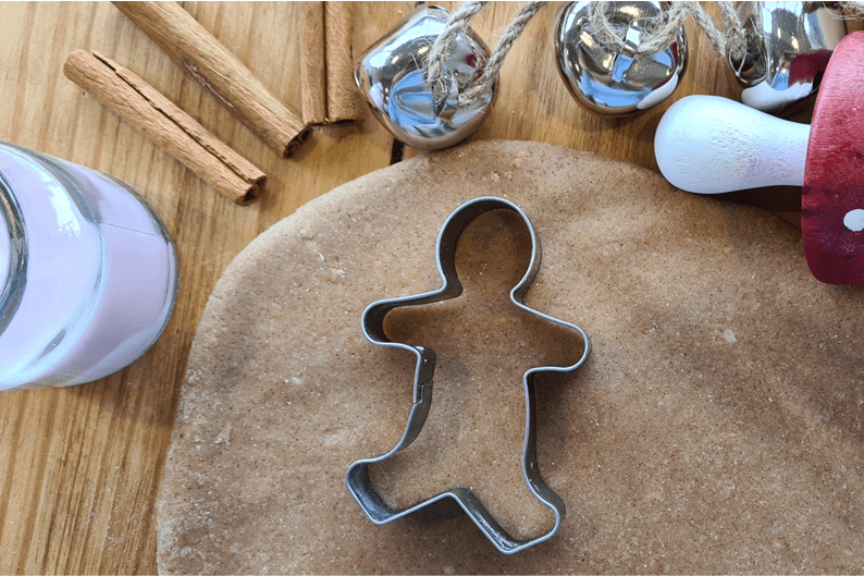 Gingerbread playdough with a cookie cutter.