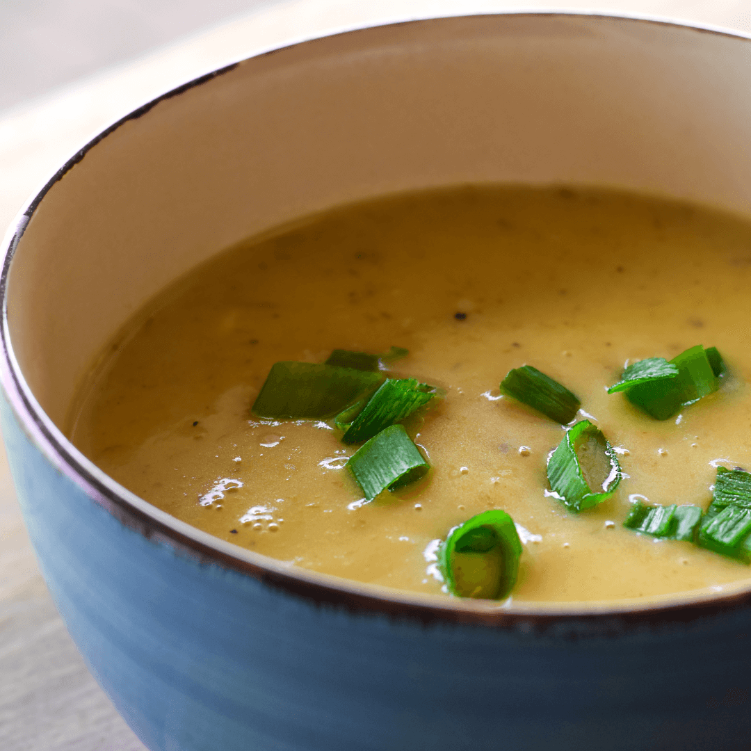 A hot bowl of homemade leek and potato soup, a comforting and nourishing dish for chilly days.