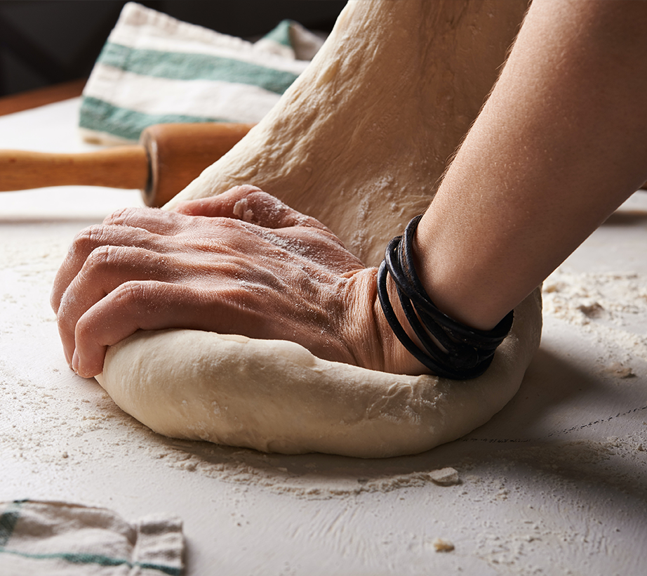 Hands kneeing dough