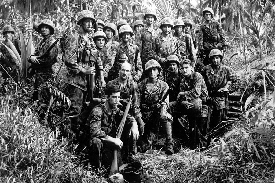 Photo of U.S. Marine Raiders gathered in front of a captured Japanese dugout on Bougainville, Solomon Islands, January 1944.