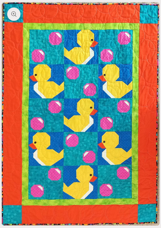 A quilt with rubber duckies and bubbles, this quilt is a wonderful quilt for a baby shower.