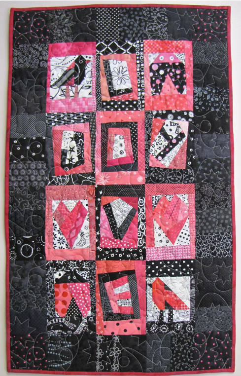 A quilt featuring a bird quilt block, lady bug quilt block and heart quilt blocks.