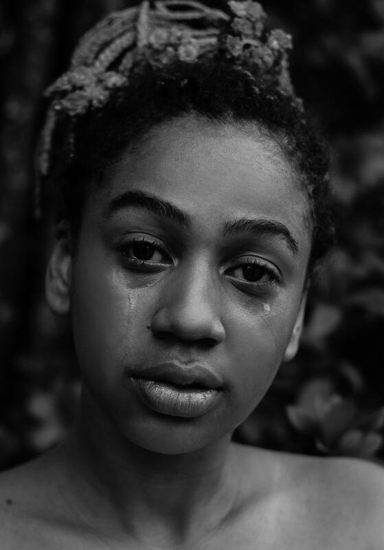 Black woman crying looking sad