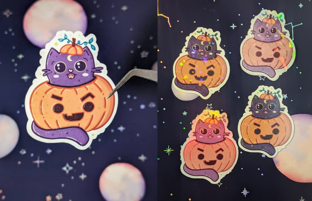 Sticker of a purple cat in an orange pumpkin