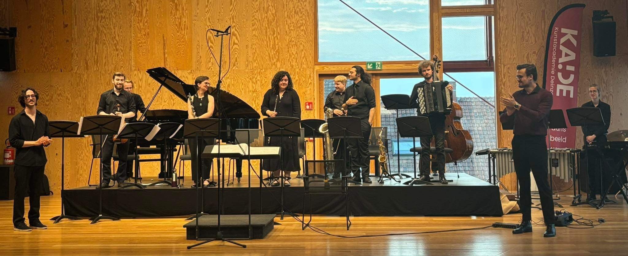 the orchestra and the composer takes in the applause after the first performance of Omphalos